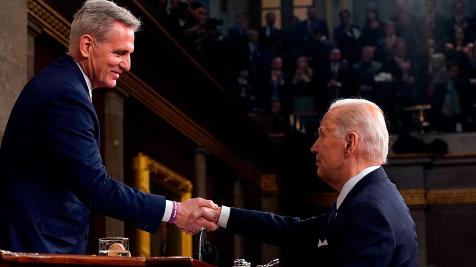 US President Joe Biden, right, shakes hands with US House Speaker Kevin McCarthy, a Republican from California